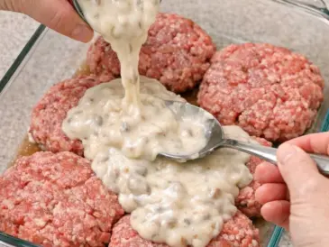 Pour cream of mushroom soup over raw ground beef patties, coupled with 2 ingredients, into a glass baking dish for a hearty supper that’s the one ev